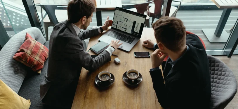 two-young-businessman-having-successful-meeting-restaurant